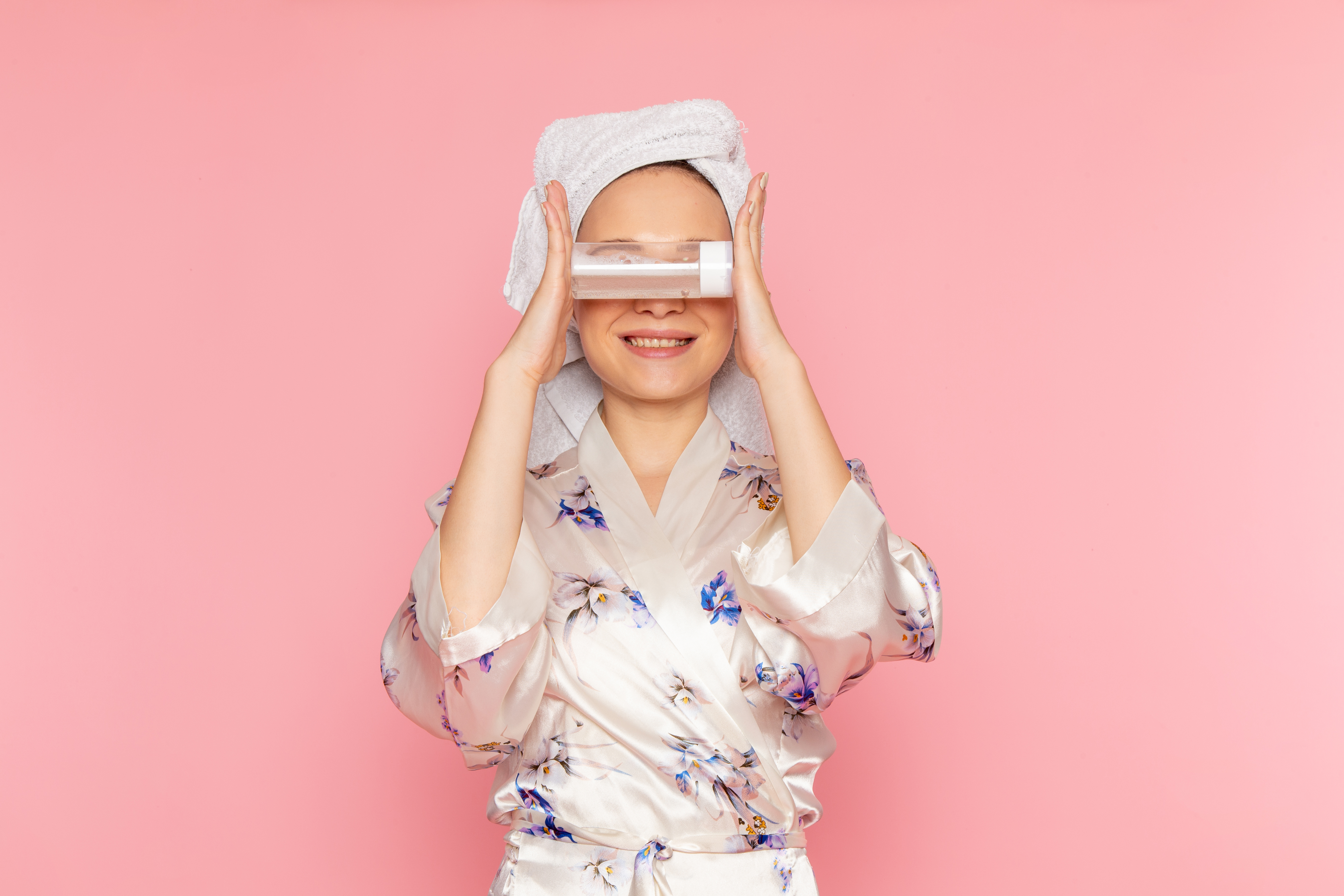 front-view-young-beautiful-lady-bathrobe-holding-make-up-cleaner-spray.jpg