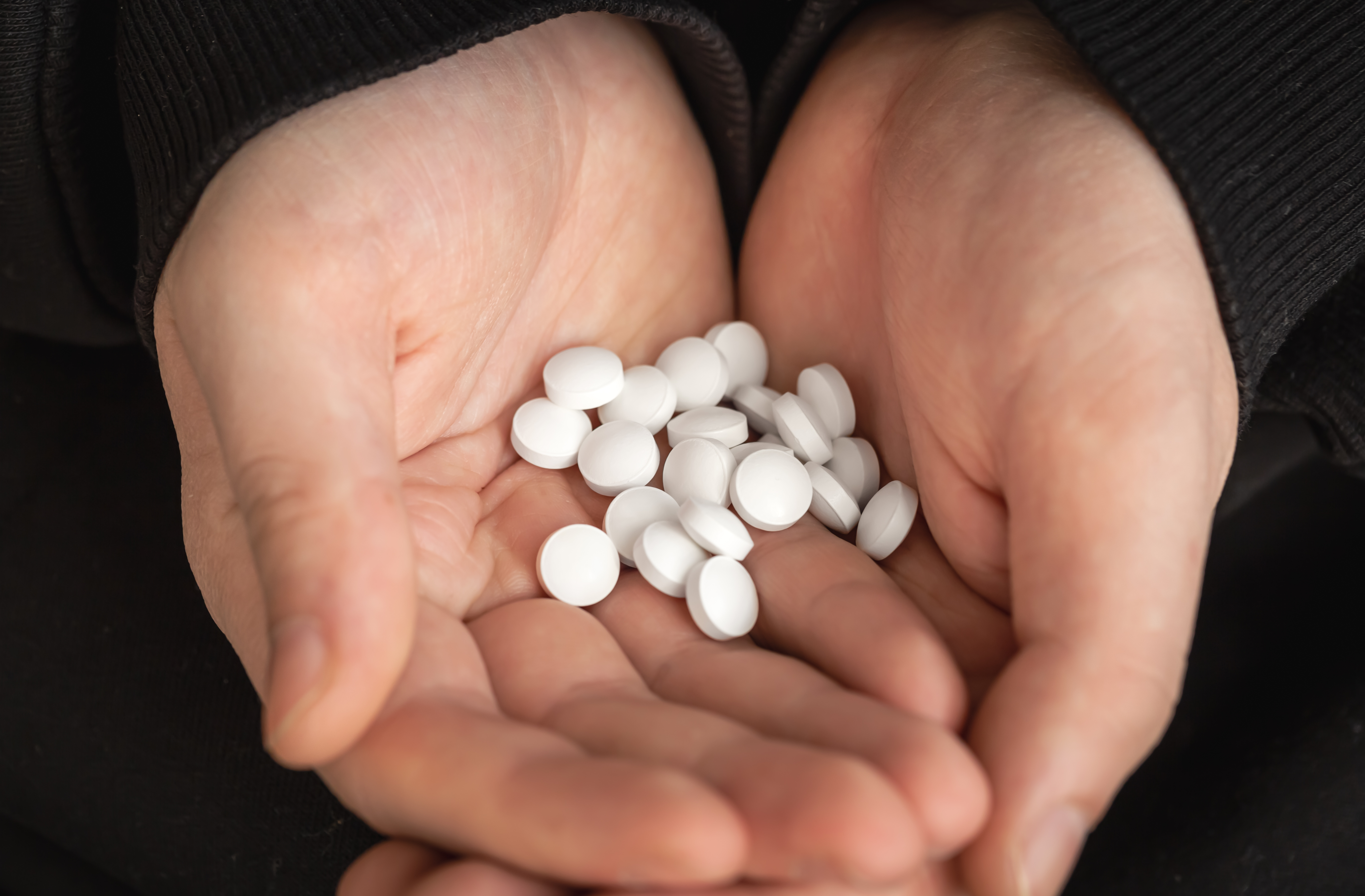 lot-white-pills-hands-adult-man.jpg